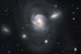 NGC 4911: Ponor po spirále do husté kupy